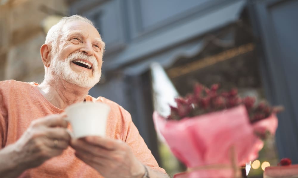 Senior man drinking coffee at a cafe near Jaybird Senior Living in Cedar Rapids, Iowa