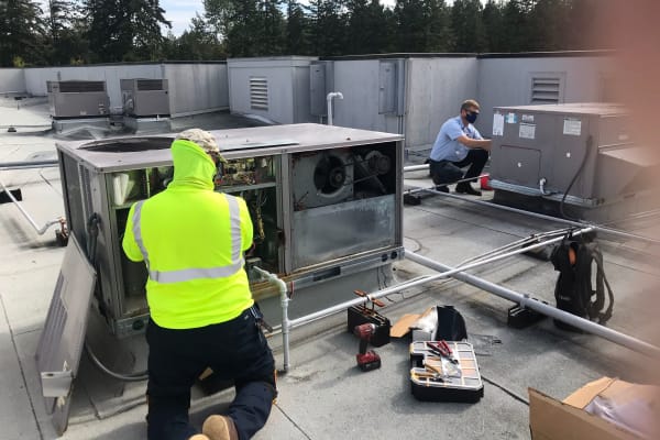 Workers installing an HVAC at  Patriots Glen in Bellevue, Washington. 