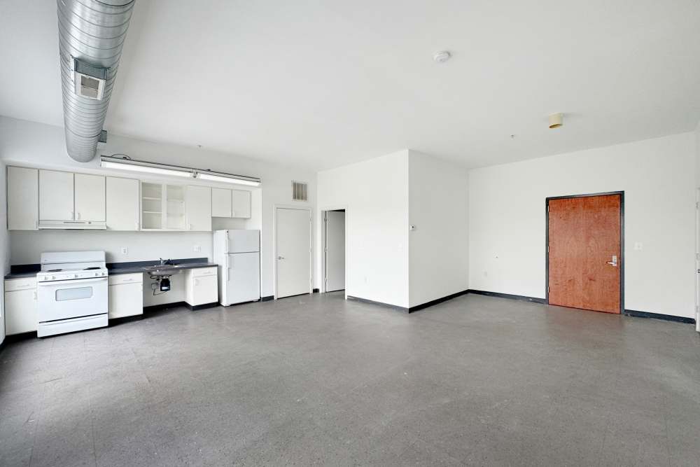 Open-concept of kitchen and living room at Artspace Lofts Mount Rainier in Mount Rainier,Maryland