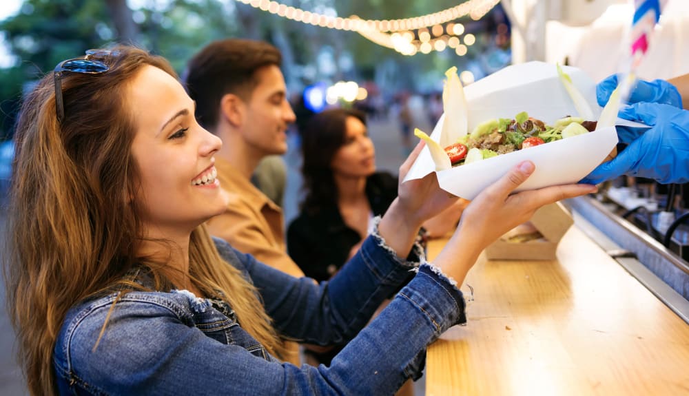 Friends eating at a local food truck near The Link Minneapolis in Minneapolis, Minnesota