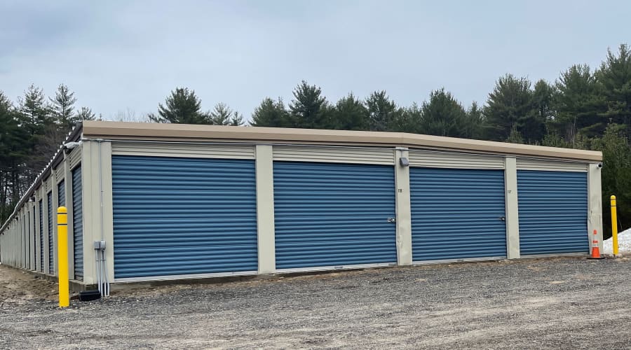 A family carrying storage boxes into their new home near KO Storage in Naples, Maine
