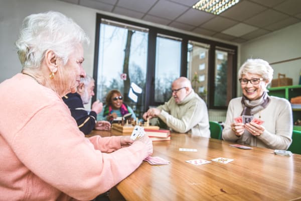 Residents playing cards at Mirror Lake Village Senior Living Community in Federal Way, Washington.