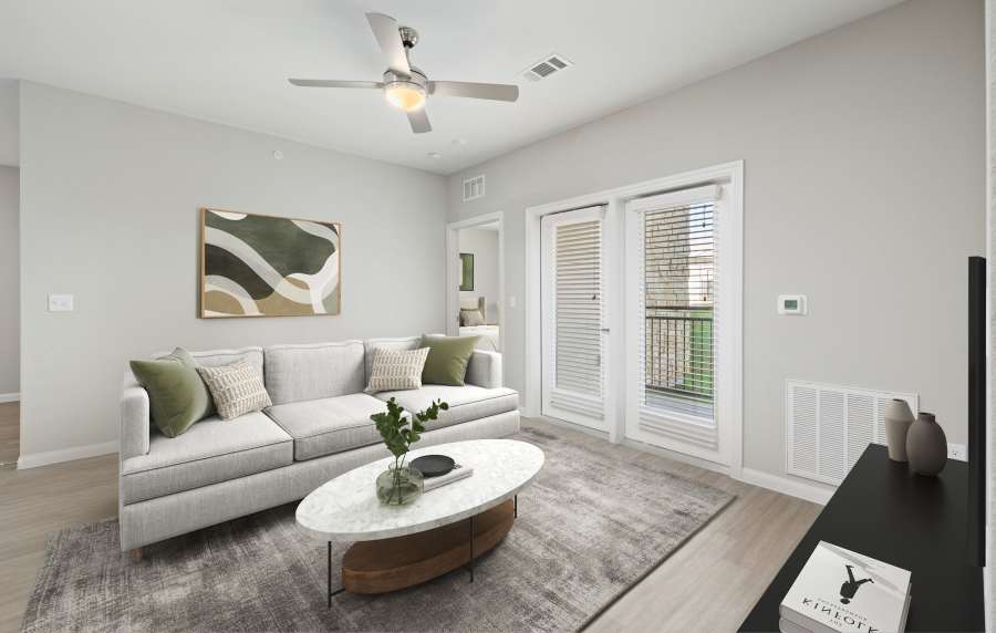 Modern living room with balcony access at Oak Creek in New Braunfels, Texas