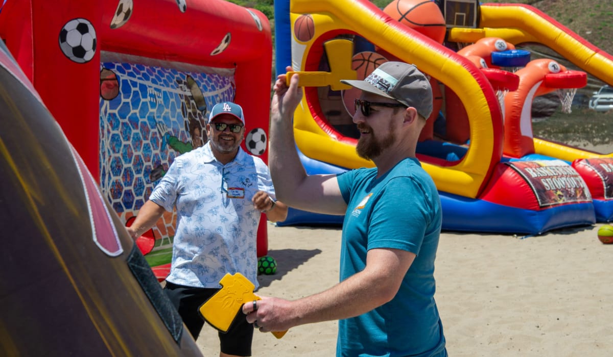 Team mates having fun at a beach event Decron Properties, Los Angeles, California