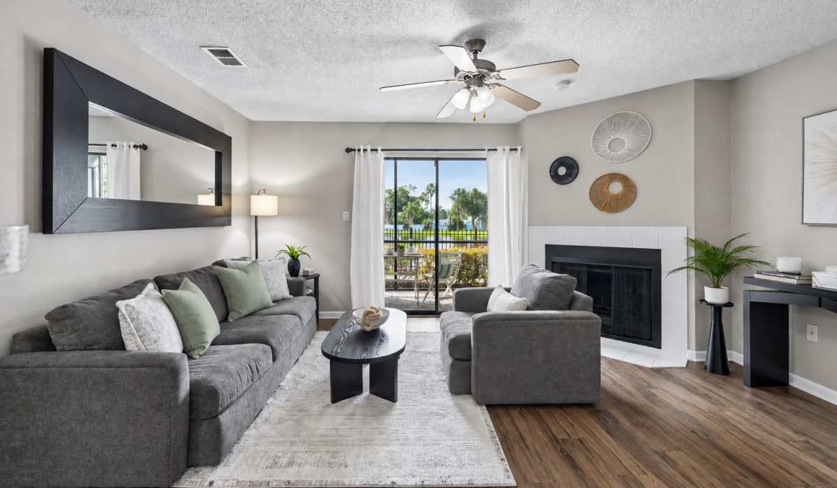 Living room with patio access and fireplace at Waterstone At Carrollwood in Tampa, Florida