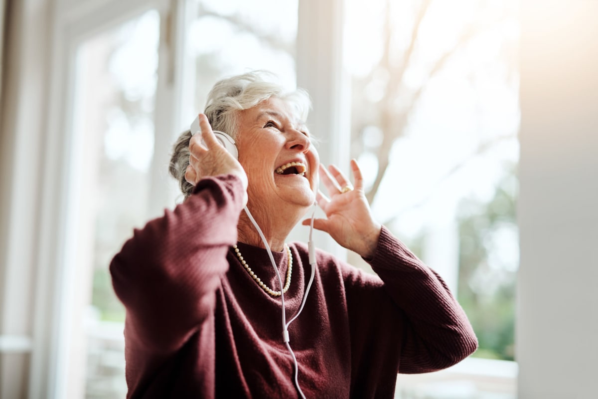 A resident listening to music at The Oxford Grand Assisted Living & Memory Care in Kansas City, Missouri