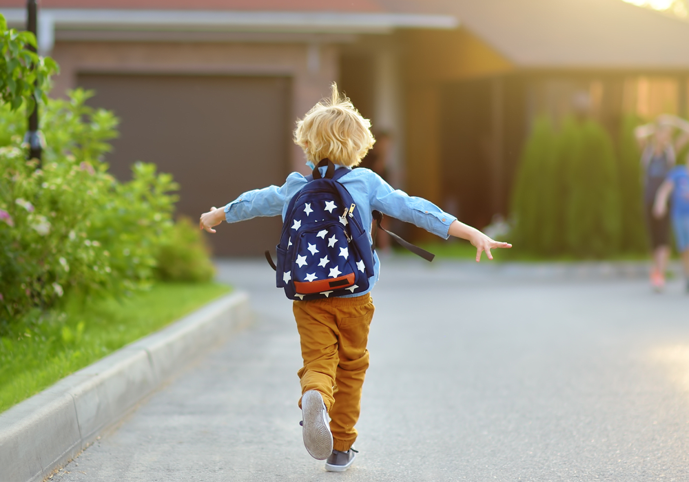 Kid walking home with his backpack on excited to be done with school for the day at BB Living Light Farms in Celina, Texas