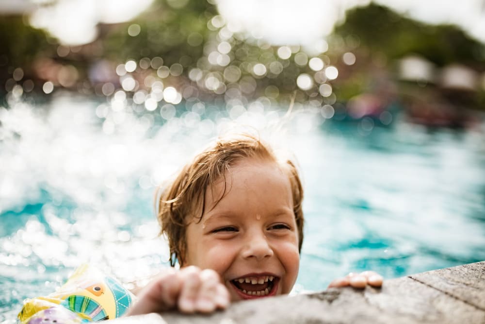Boy swimming at the pool at The Carter in Grapevine, Texas