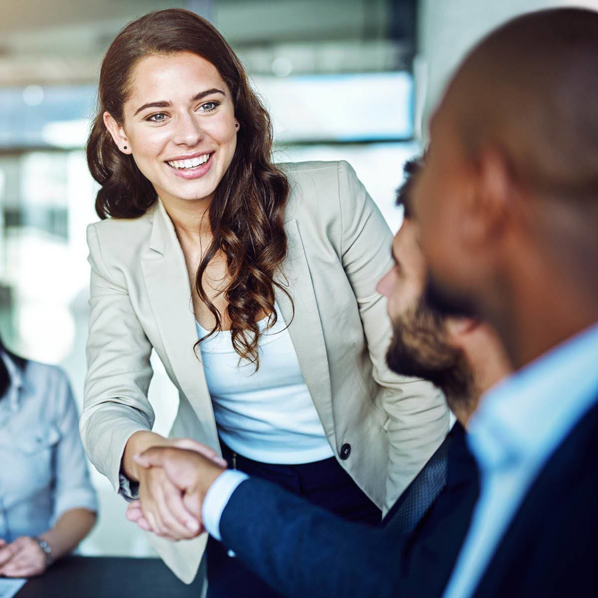 Woman and man shaking hands at CAPREIT in Rockville, Maryland