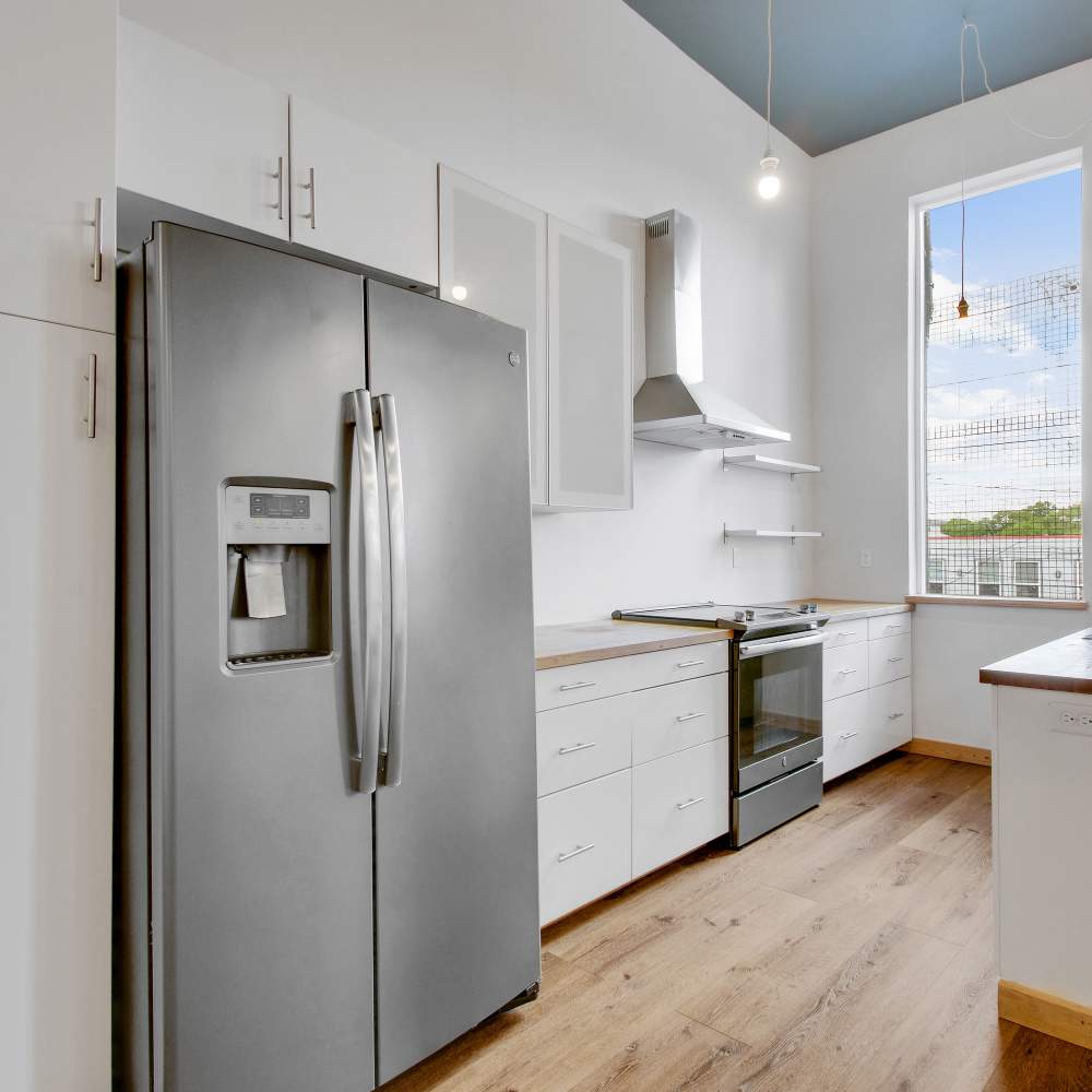 Kitchen with stainless-steel appliances at The Lofts at 305 in Bryan, Texas