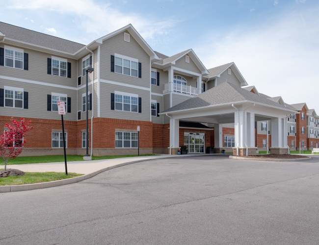 Exterior of building with courtyard at The Harmony Collection at Roanoke - Assisted Living in Roanoke, Virginia