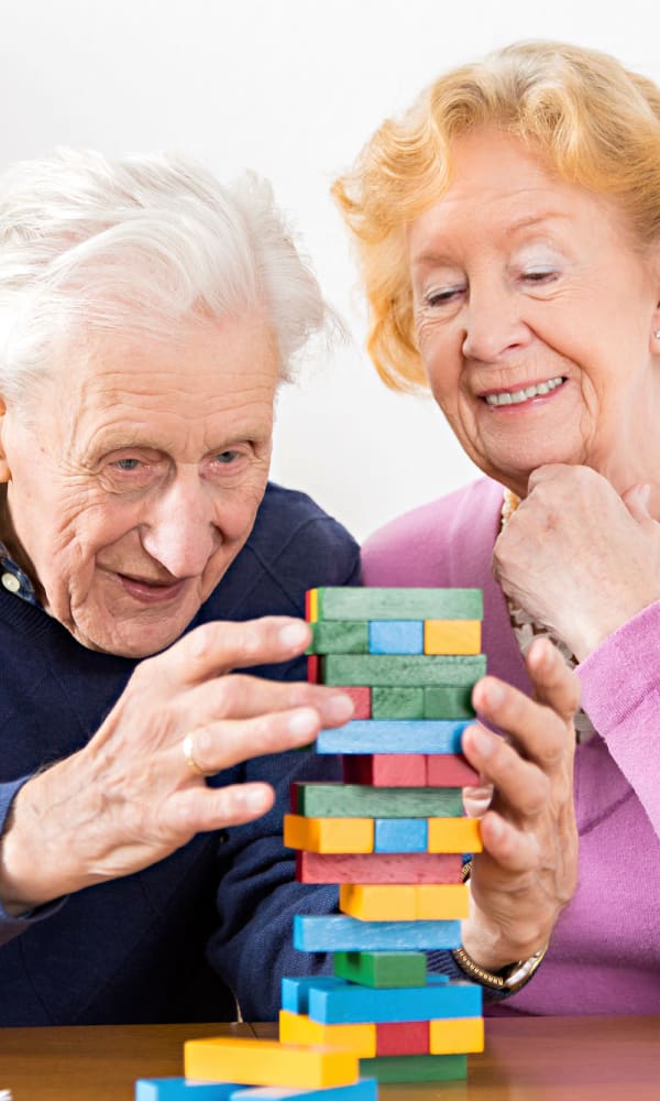 Senior couple playing jenga at The Retreat at Fishersville in Stuarts Draft, Virginia