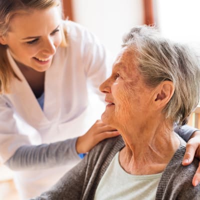 A caregiver talks to a resident at The Sanctuary at West St. Paul in West St. Paul, Minnesota