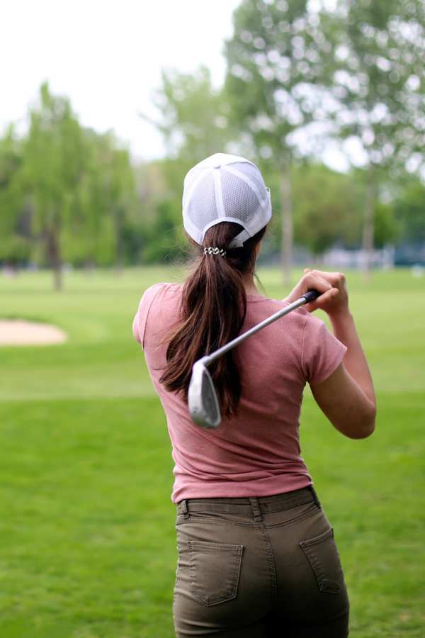 Resident playing golf in near The Abbey At Enclave in Houston, Texas