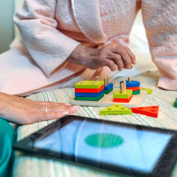 Resident and caretaker performing a memory exercise at Pacifica Senior Living Escondido in Escondido, California