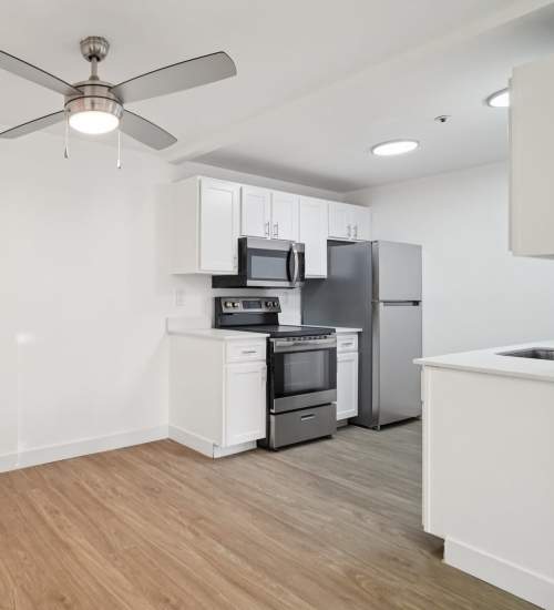 Kitchen with stainless steel appliances at Foundry on Fifth in Renton, Washington