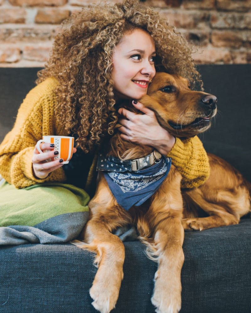 Resident with her pet in apartment at Mattress Factory Lofts in Atlanta, Georgia