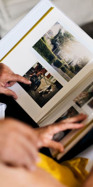 Resident looking at a photo album at a WISH community