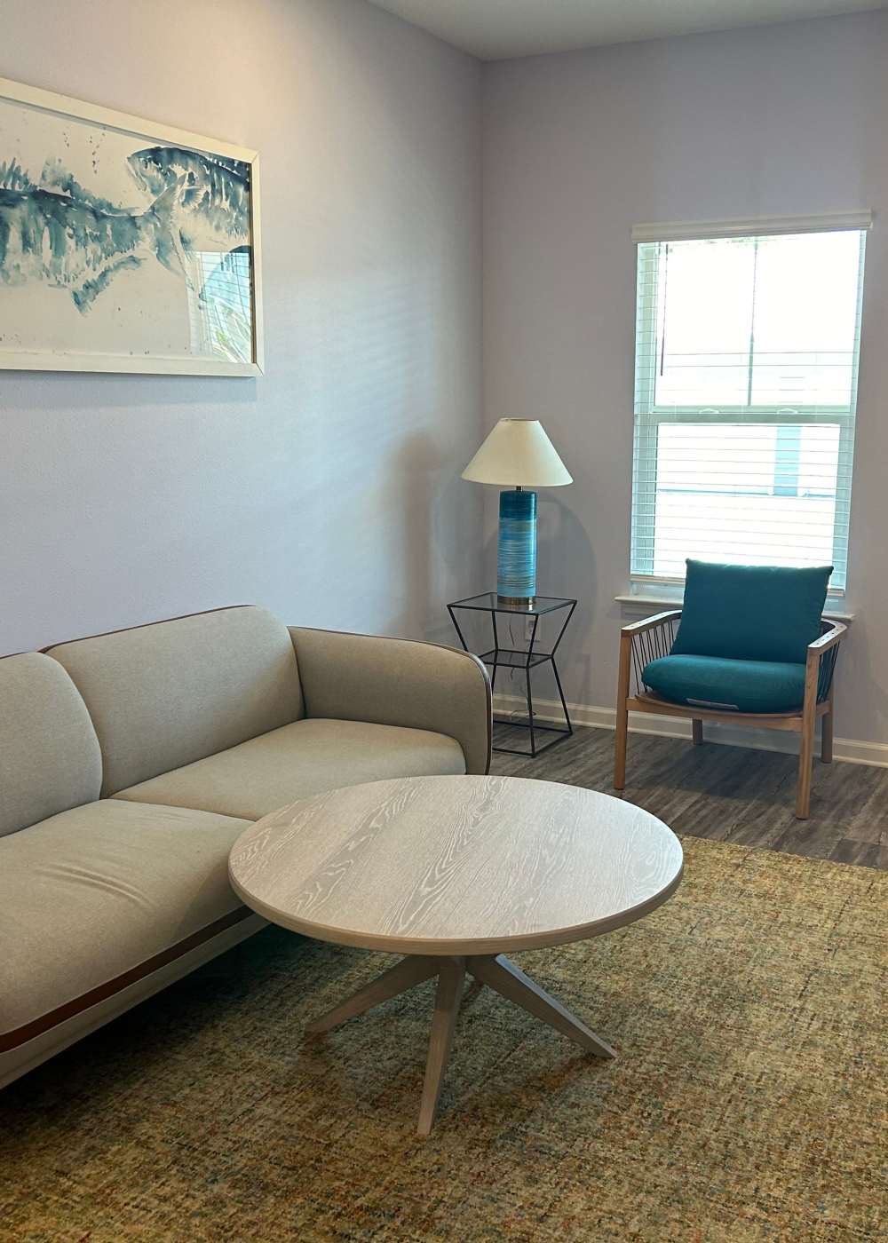 Spacious living room with large couch, chair and coffee table at Las Colinas in Foley, Alabama