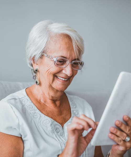 Residents enjoying her tablet at Vancouver Pointe in Vancouver, Washington