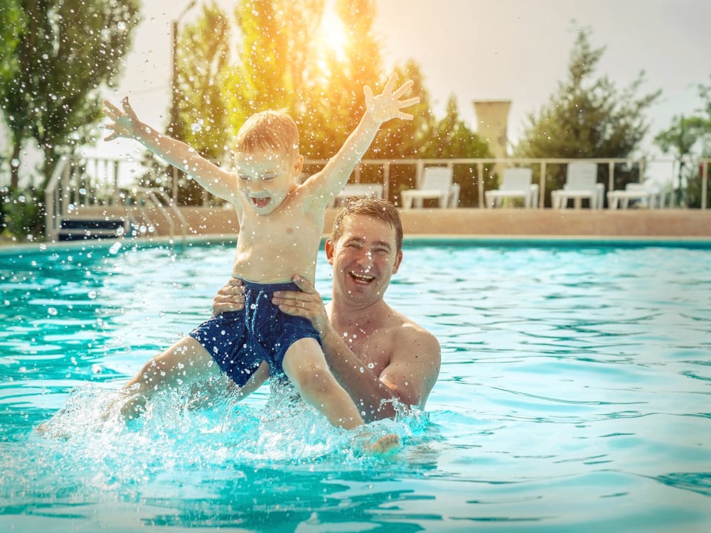 Father and his kid in the pool at TerraLane on Cotton in Surprise, Arizona