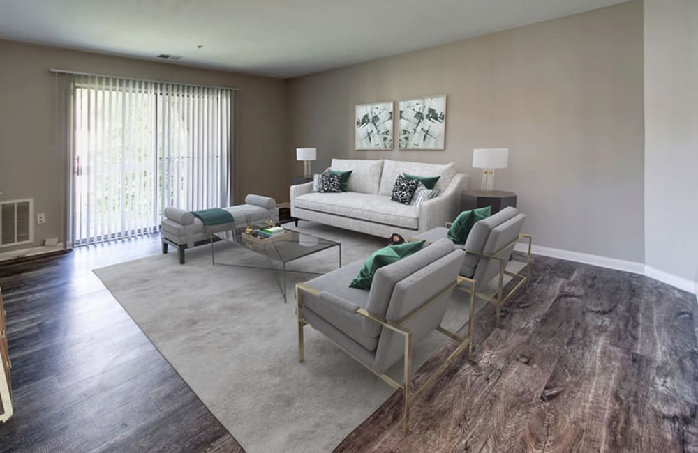 Living room with plank flooring in a model home at Northampton Apartment Homes in Largo, Maryland