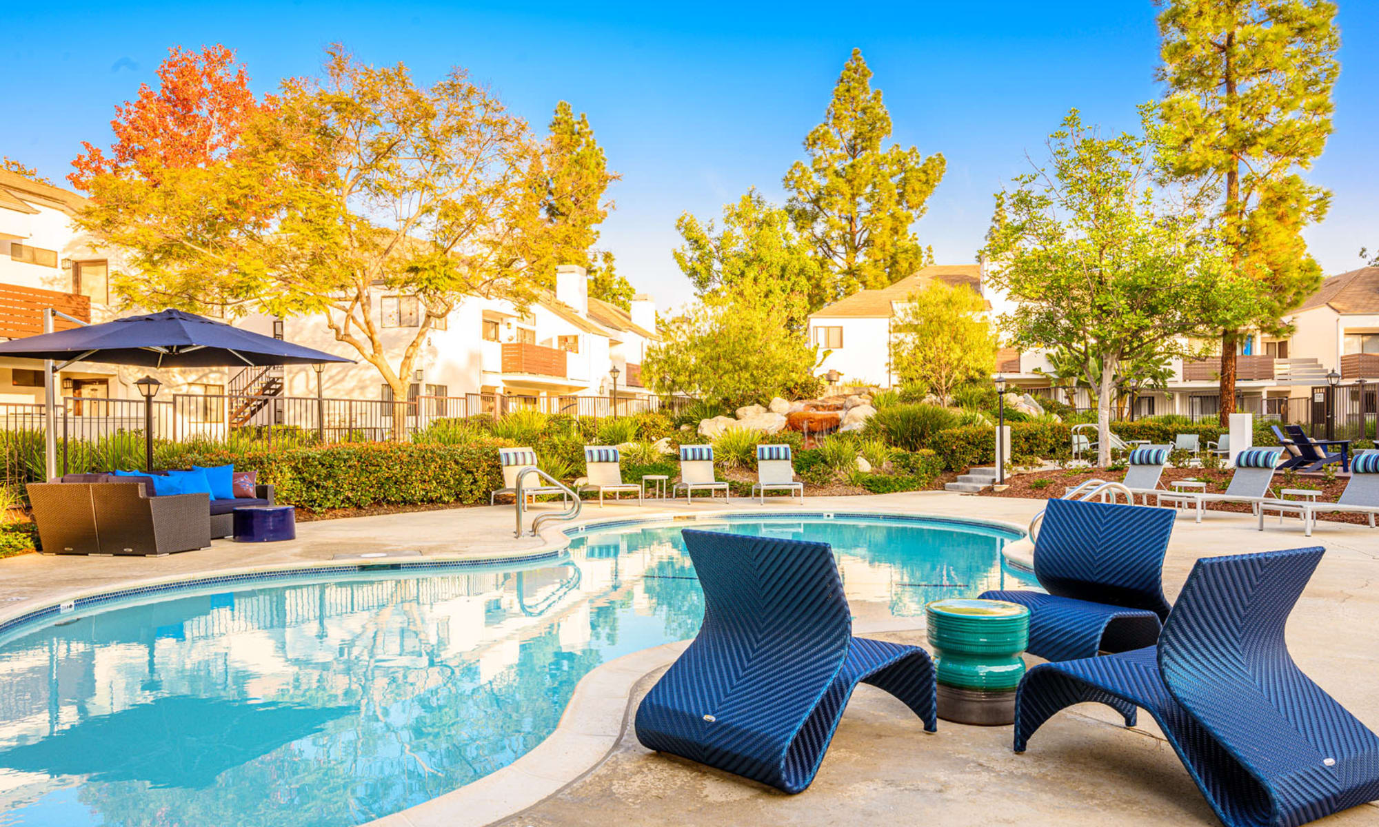 Luxurious lounge areas near the pool on a beautiful afternoon at Sendero Huntington Beach in Huntington Beach, California