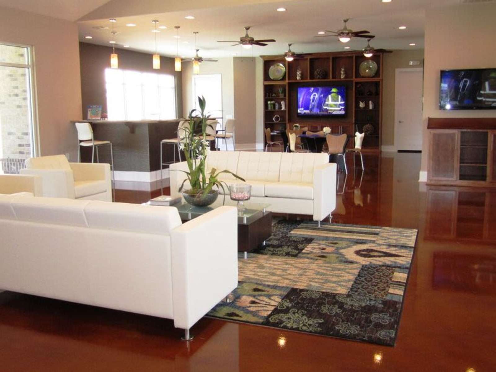 Clubhouse interior with shiny floor and two white sofas
