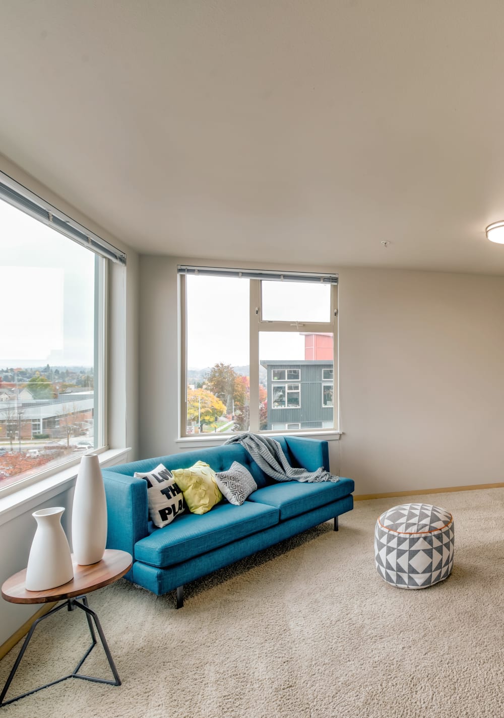 Plush carpeting in the living area of an open-concept model home at Verse Seattle in Seattle, Washington