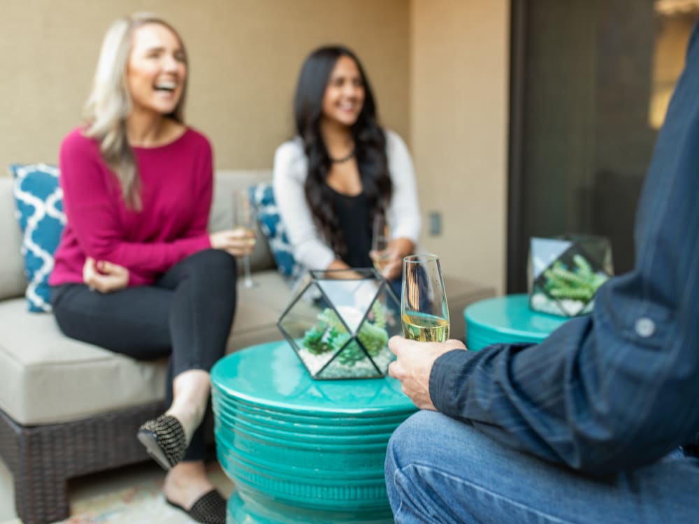 Residents friends enjoying drinks on their private patio at The Hyve in Tempe, Arizona