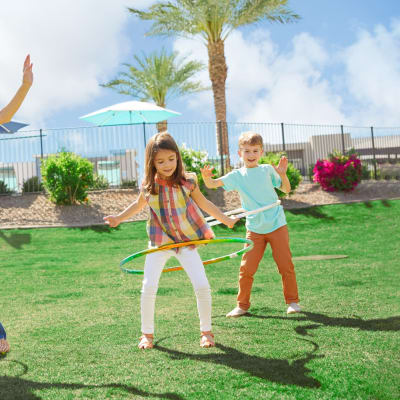 Little kid playing in park at Las Casas at Windrose in Litchfield Park, Arizona