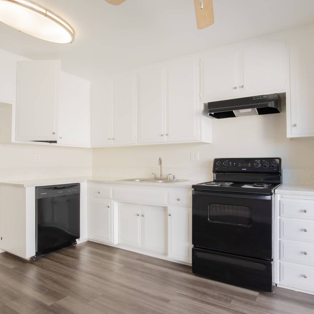 Bright kitchen with granite countertops at Terramonte Apartment Homes in Pomona, California