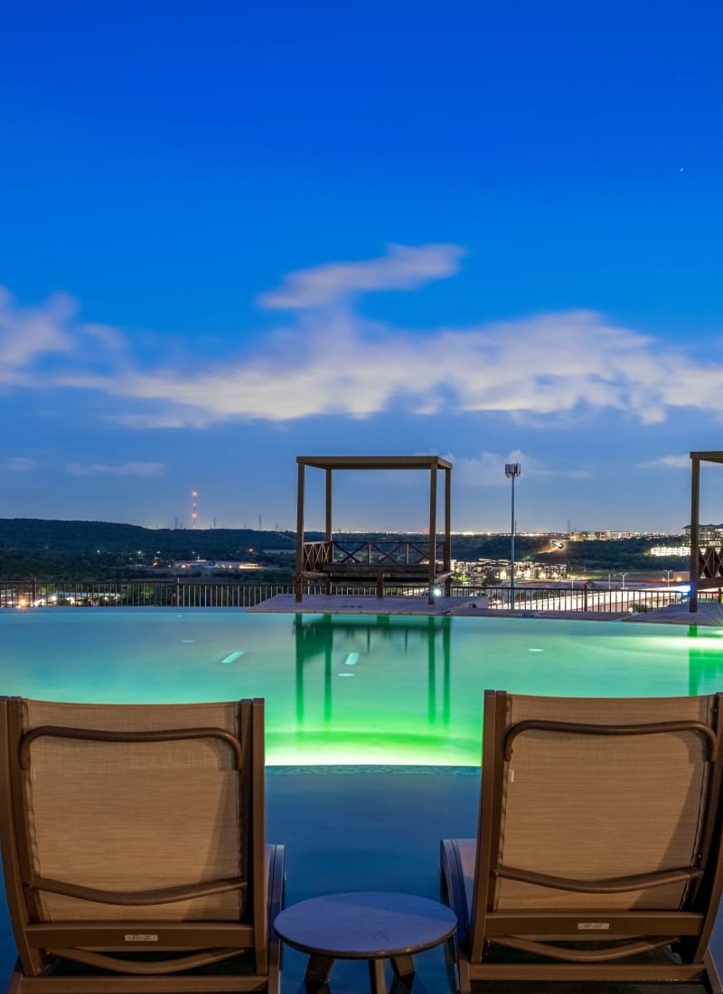 Pool chairs overlooking the city at Marquis Cresta Bella in San Antonio, Texas