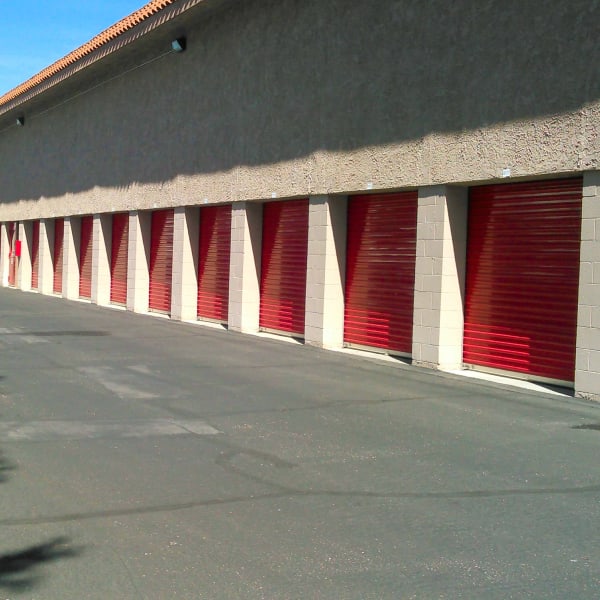 Outdoor storage units with bright doors next to RV spaces at StorQuest Self Storage in Camarillo, California
