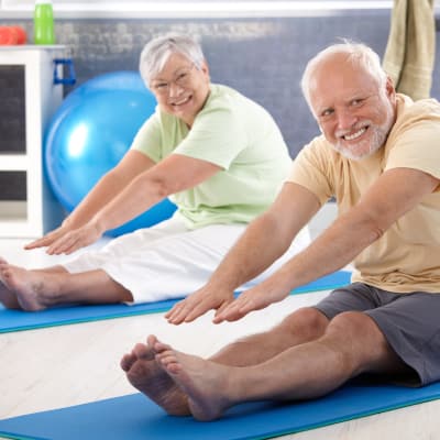 Senior couple stretching in yoga class at Stonecrest of Anderson Township in Cincinnati, Ohio