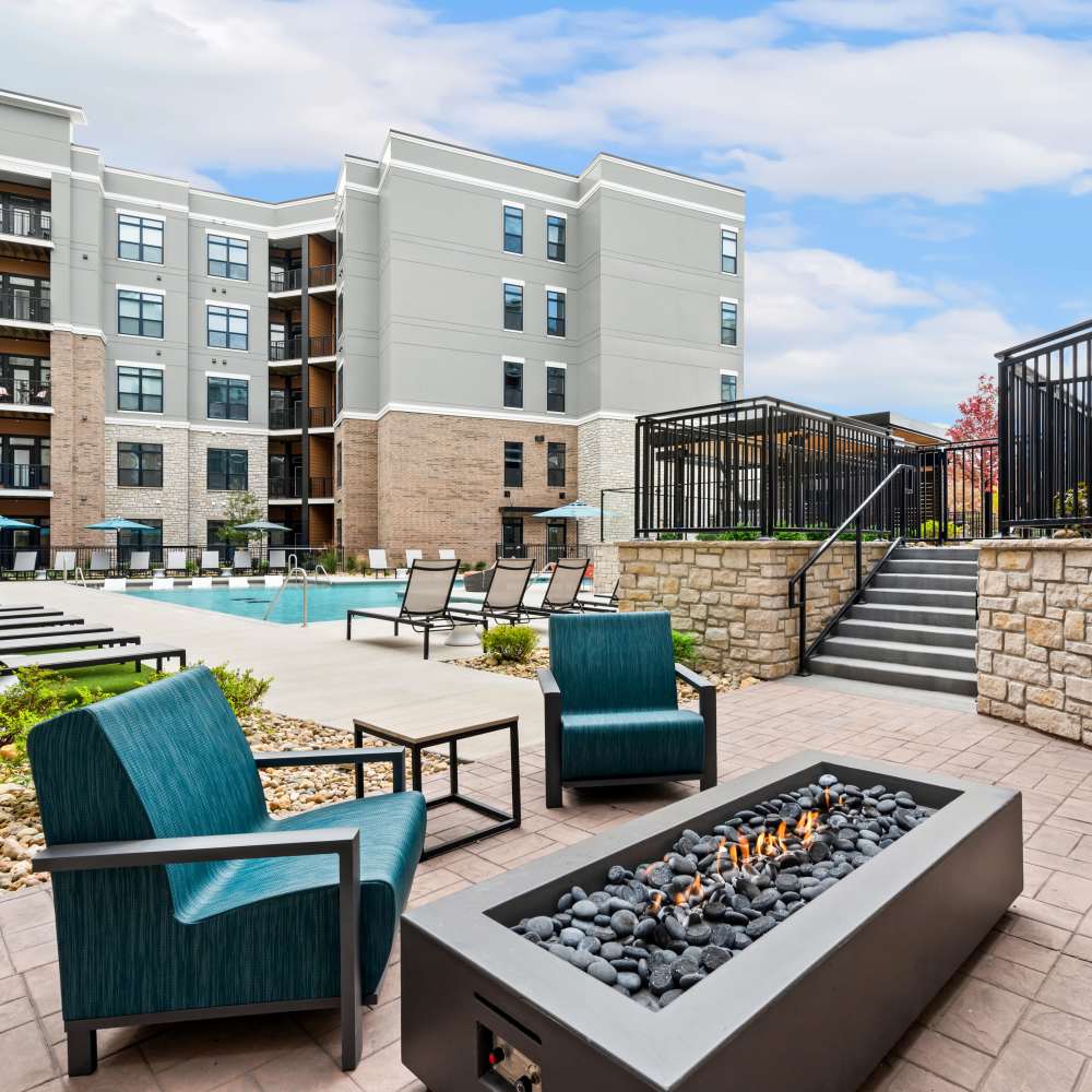 Outdoor seating with firepit near swimming pool at Neo Vantage Point in Maryland Heights, Missouri