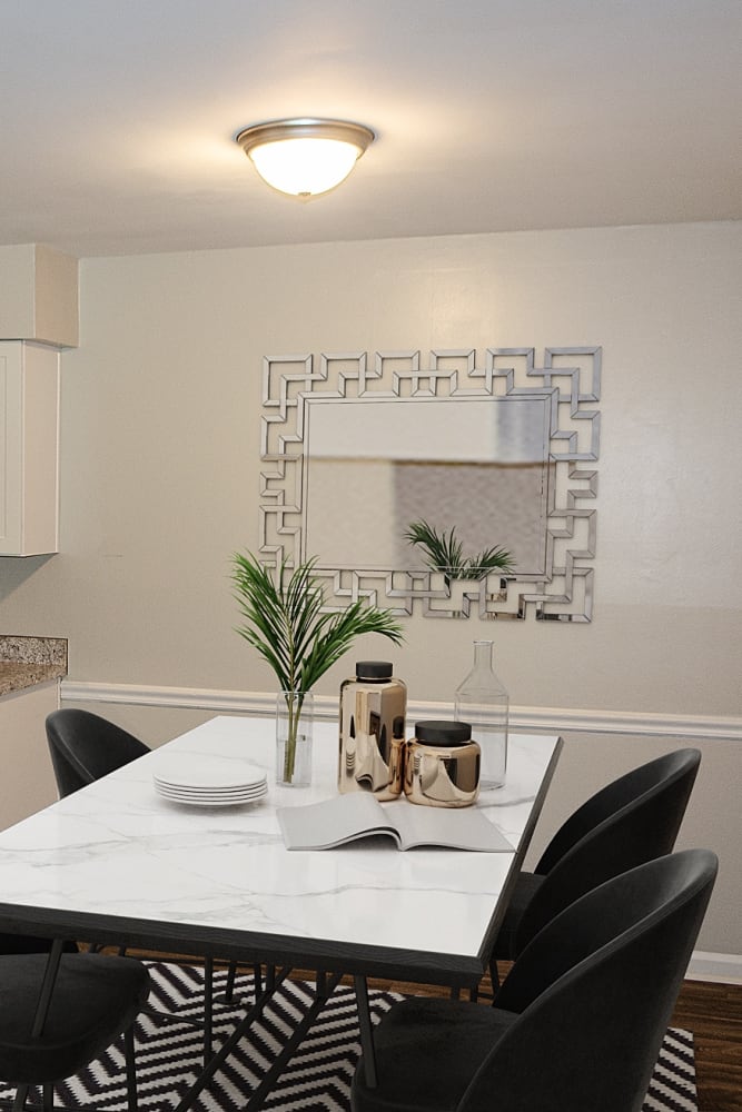 An apartment dining room with wood-style flooring at Georgetowne Woods in Gastonia, North Carolina