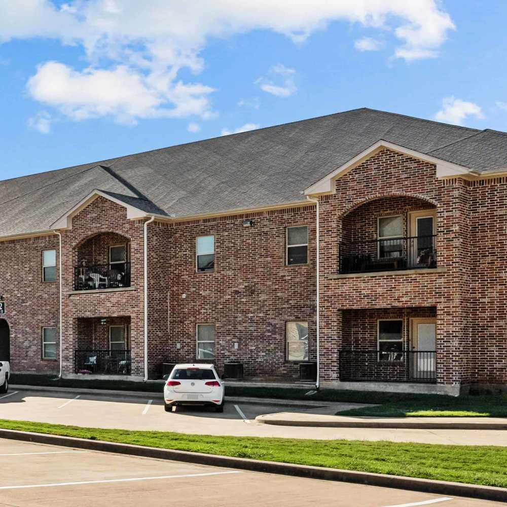 View of apartment with balconies at The Arbors of Mineola in Mineola. TX