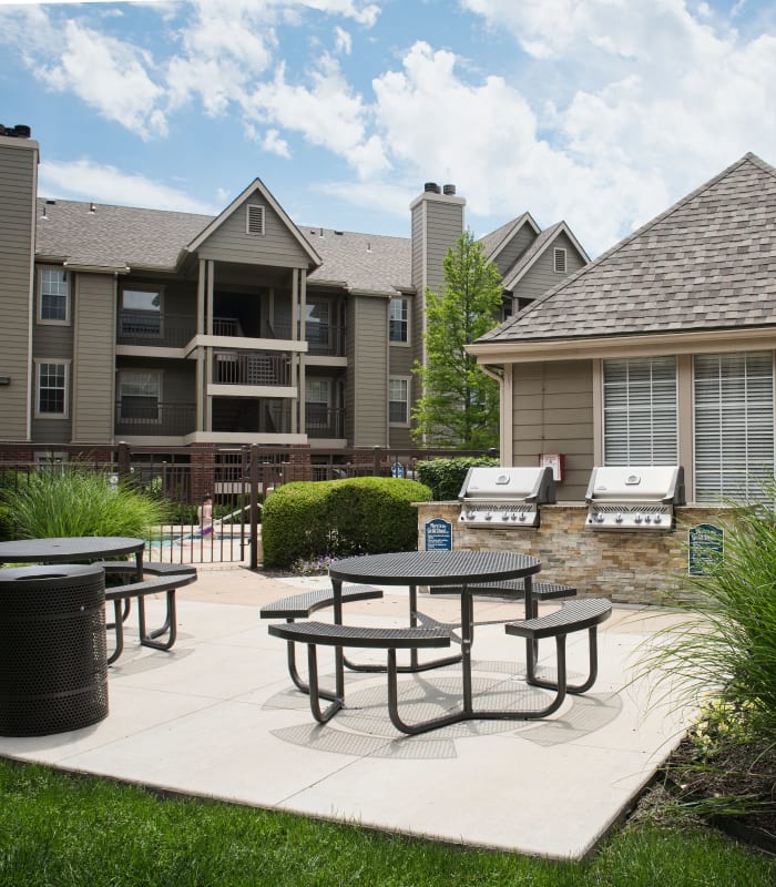 Patio area with bbq and benches at Crown Chase Apartments in Wichita, Kansas