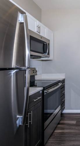 Apartment kitchen with wood-style flooring at The Dakota at Governors Ranch in Littleton,Colorado