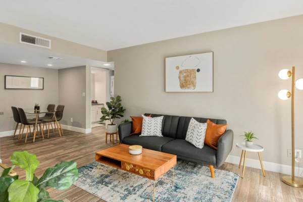 Spacious living room with couch, coffee table and more at Raystone Apartments in Phoenix, Arizona