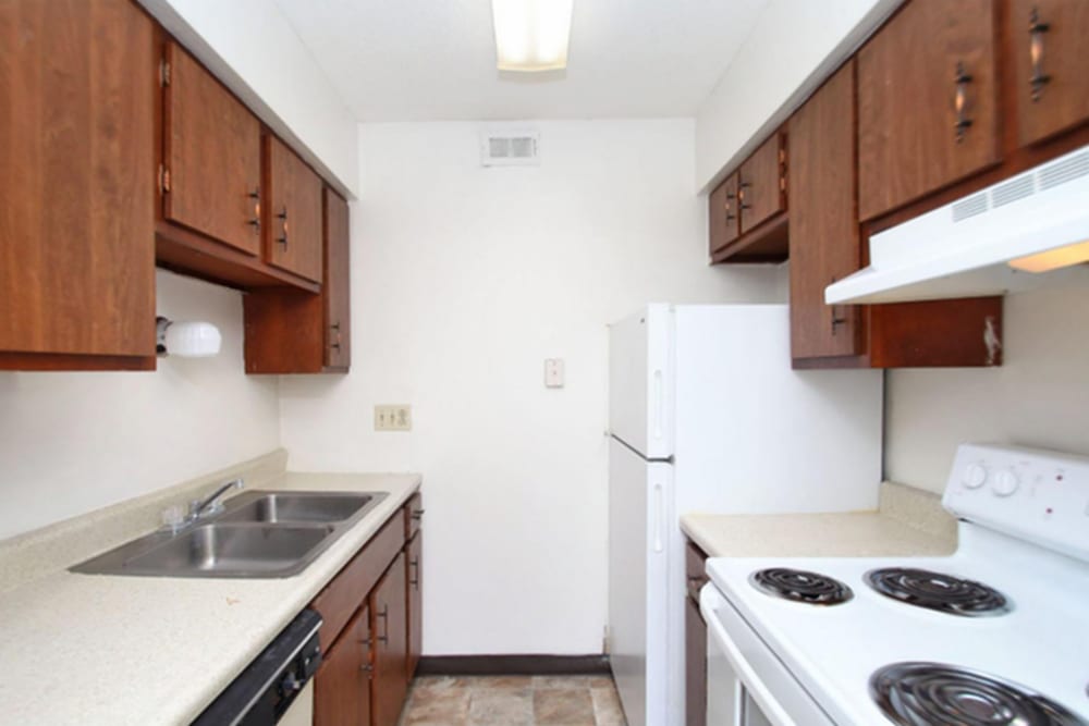 Kitchen with wooden cabinets at Towne Oaks in Baton Rouge, Louisiana