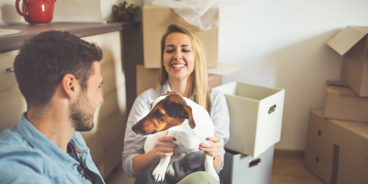 A couple and their dog taking a break while packing for storage at U-Lock-It Self Storage in Vancouver, Washington