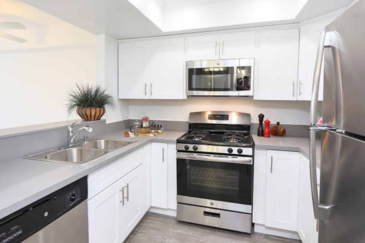 Kitchen with stainless-steel appliances at Kingsley Drive Apartments, Los Angeles, California