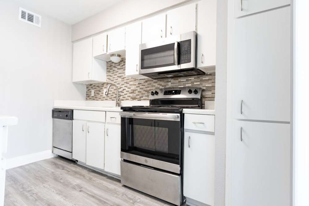 Modern kitchen with white cabinets at San Mateo Forest in Dallas, Texas