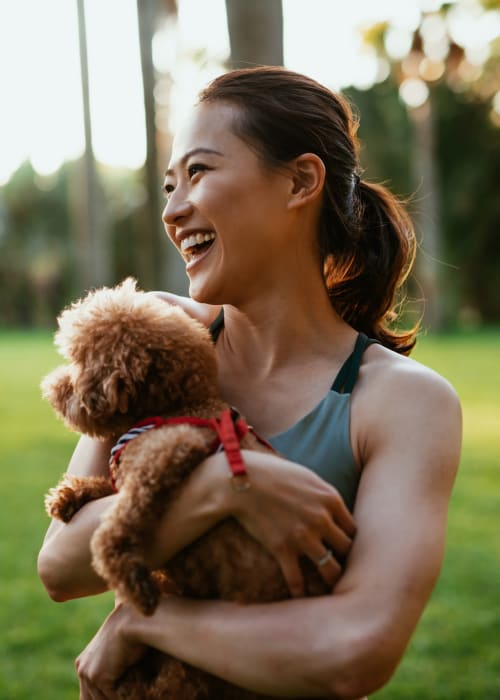 Resident holding her dog at Parc at Lyndhurst in Lyndhurst, New Jersey