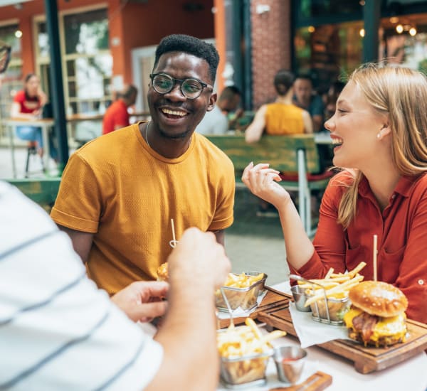 A smiling group of friends out having a meal near Residences at Congressional Village in Rockville, Maryland