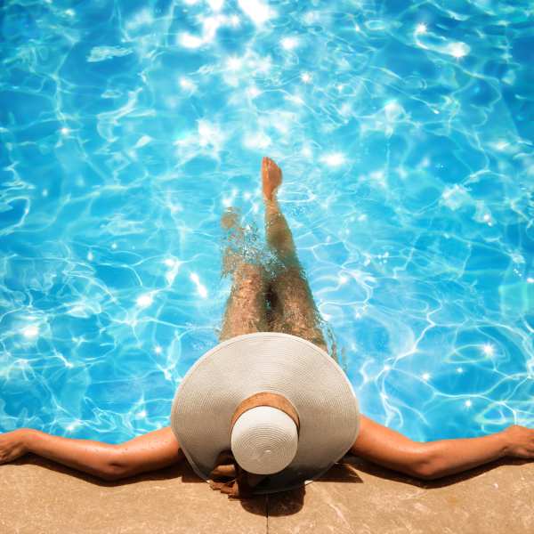 Woman relaxing at the poolside at The Abbey at Sonterra in San Antonio, Texas