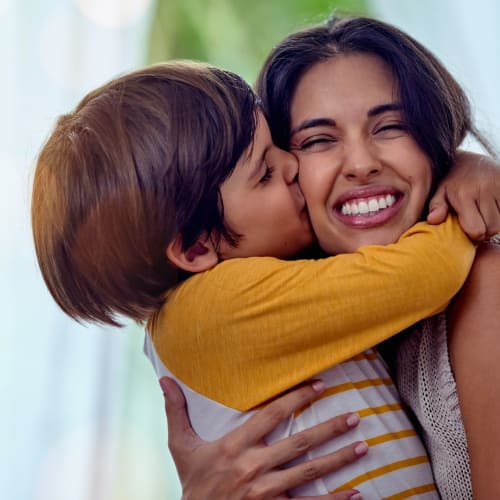 A kid hugging his mother at Ramona Vista in Ramona, California