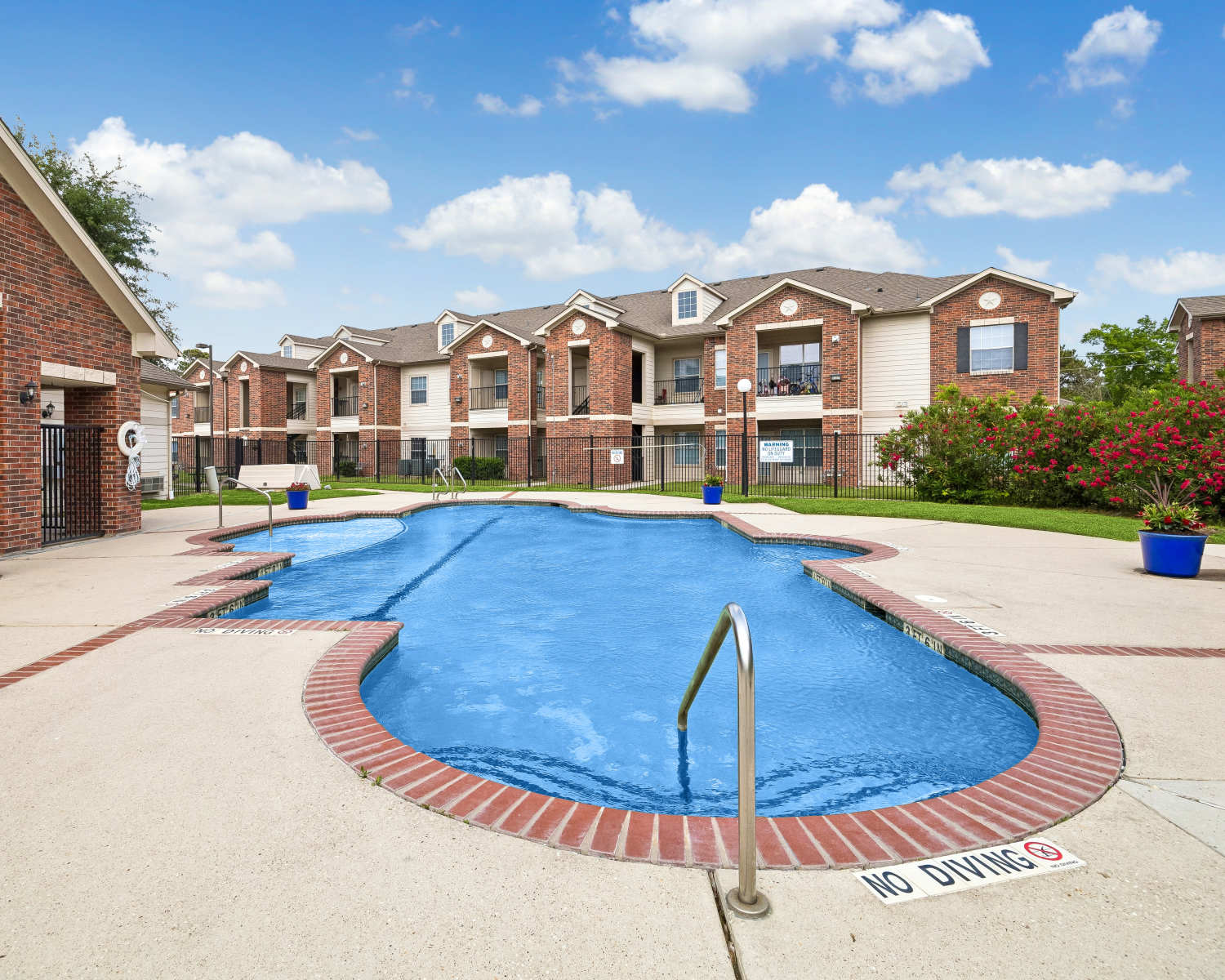 Swimming pool with surrounding sundeck at Atascocita Pines in Humble, Texas